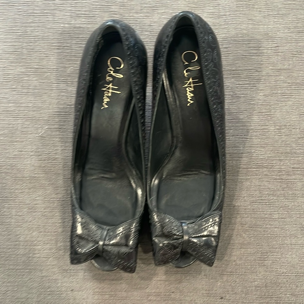 Cole haan peep toe pumps with a platform.